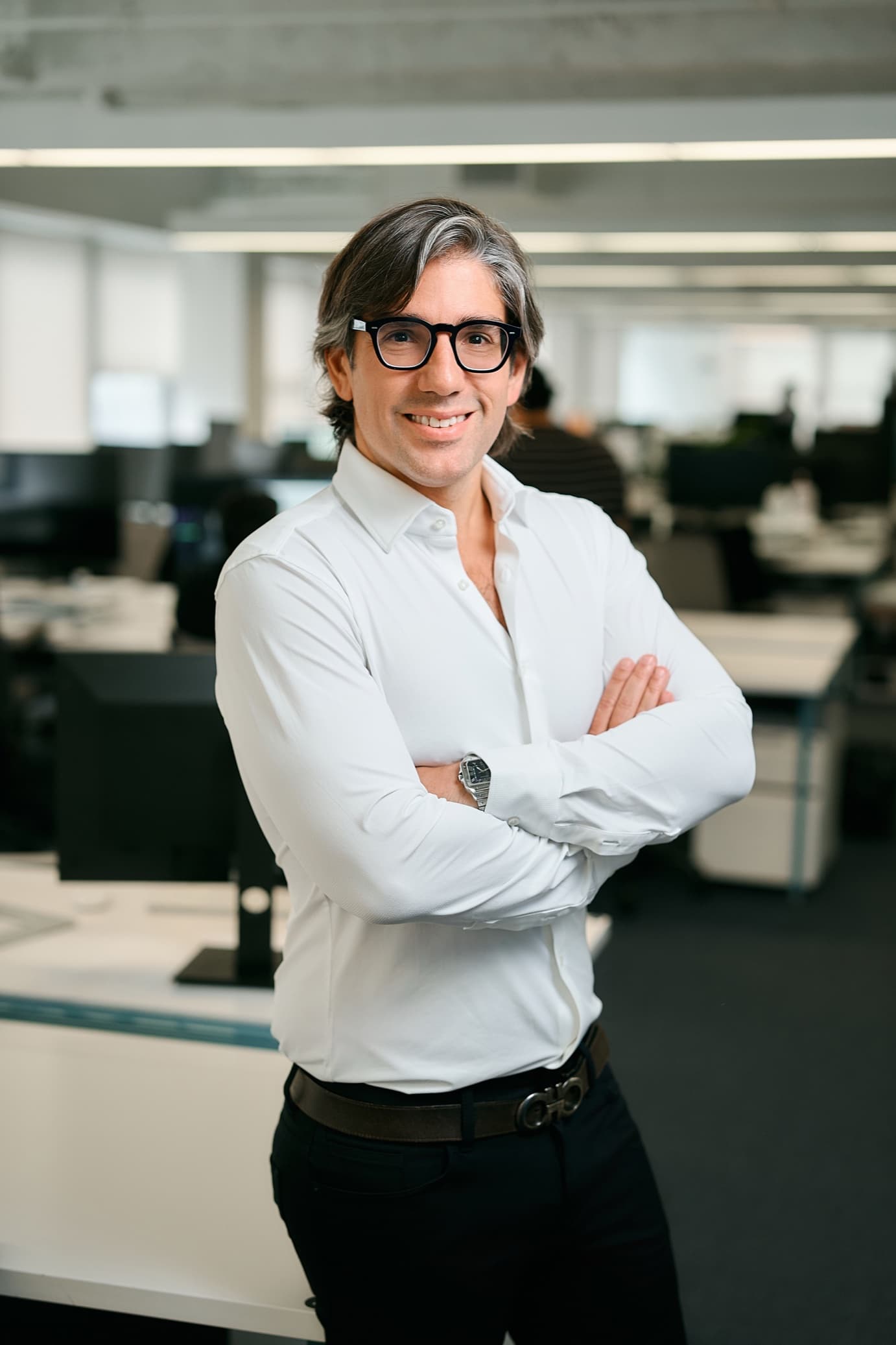 Michael Rangel, arms crossed in the office